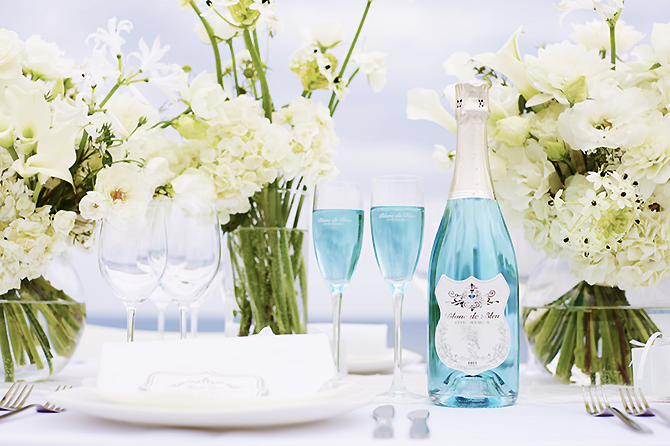 Blanc de Bleu California lgbt wedding bartenders bottle and white flowers on table
