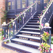 colonial wrought iron stairwell with climbing flowering vines at DACOR Bacon House