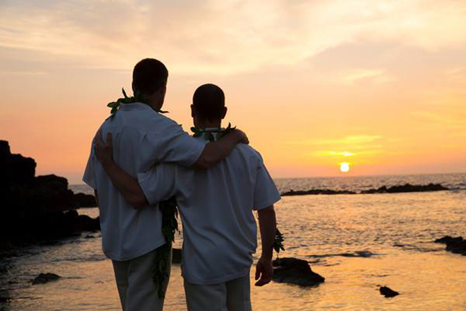 Purple orchid Wedding - Gay couple watching the sunset over a rocky beach