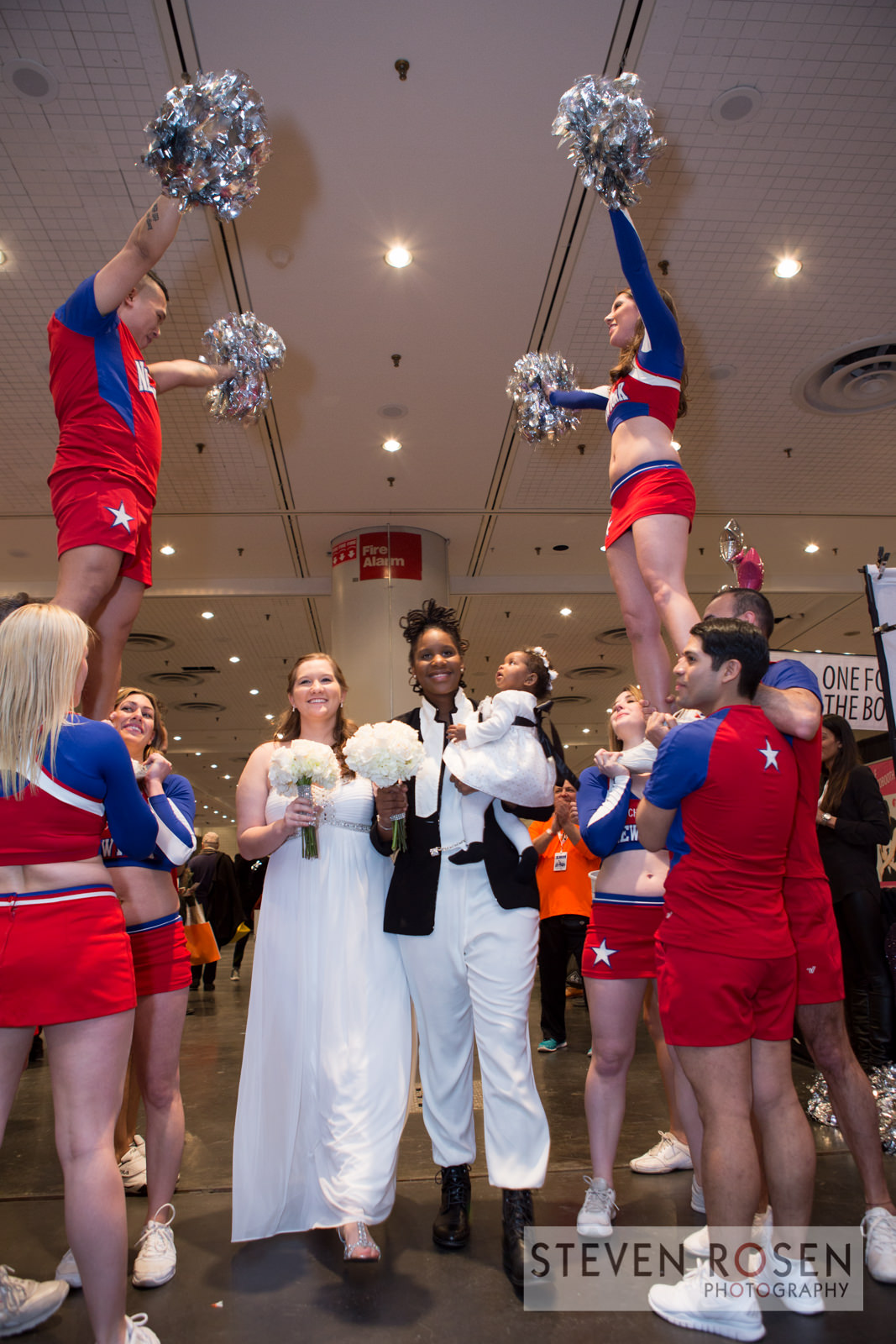 Val and Chelsey LGBT Wedding at the Original LGBT EXPO in NYC - Cheerleader Wedding Arch