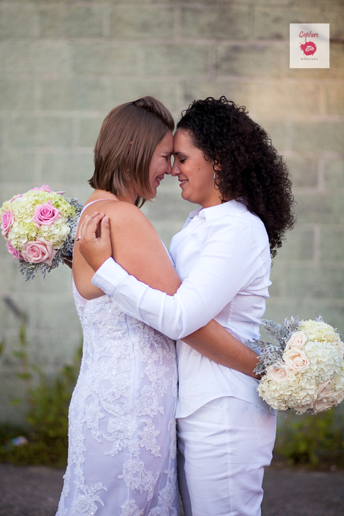 Capture Photography - Candid photo of brides embracing