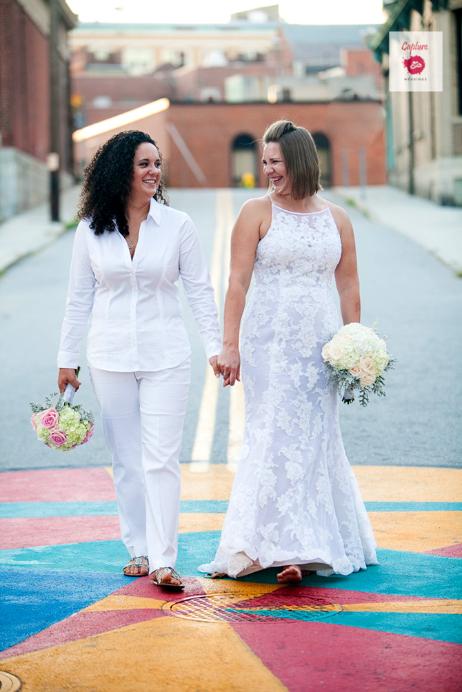 Capture Photography - Street photograph of LGBT brides with bouquets holding hands
