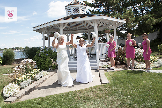 Capture Photography - Happy brides raising hands up