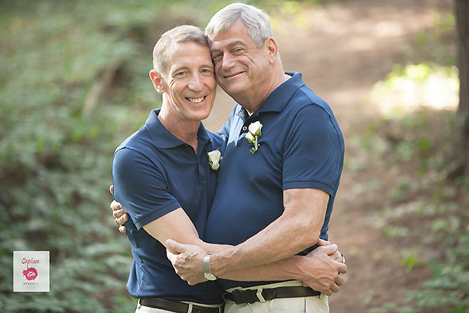 Capture Photography - grooms wearing blue shirts holding each other