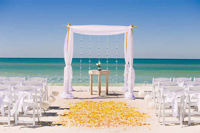 Tide the Knot Beach Weddings - Wedding alter and yellow flower petals on the beach