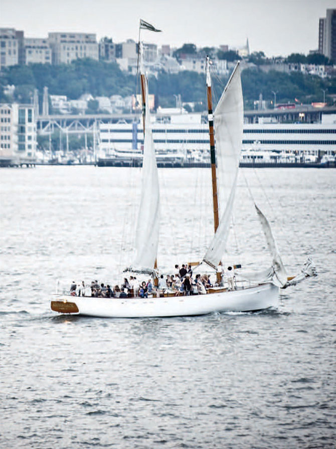 Sunset Terrace at Chelsea Piers sail boat on the Hudson River