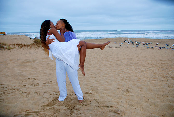 Rev. Tanya Young Outer Banks Weddings - Brides kissing on the beach