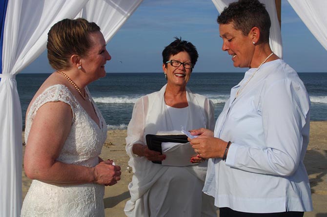 Rev. Tanya Young Outer Banks Weddings - Lesbian brides exchanging vow