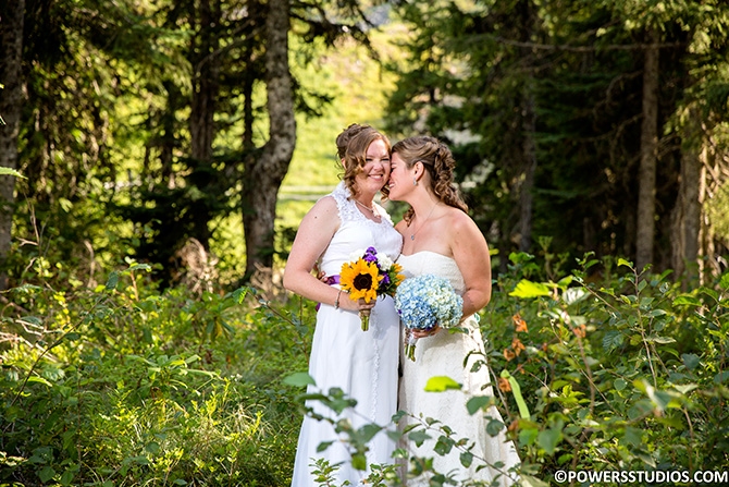 Powers Studios - Color image of lesbian brides in wooded area