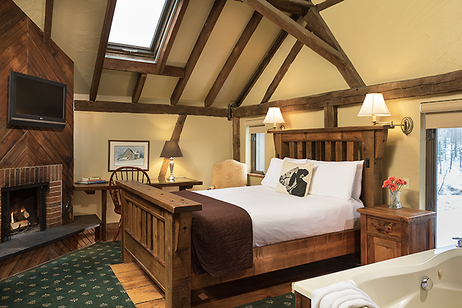Large wood frame king bed wooden beam ceinlings at Glasbern Fogelsville, PA