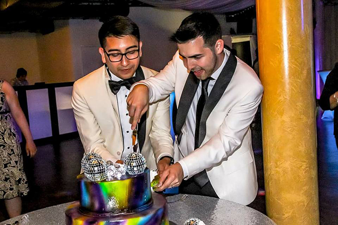 LGBT Couple cutting wedding cake - Dallas, Texas LGBT Wedding Reception Venue - Jupiter Gardens Event Center