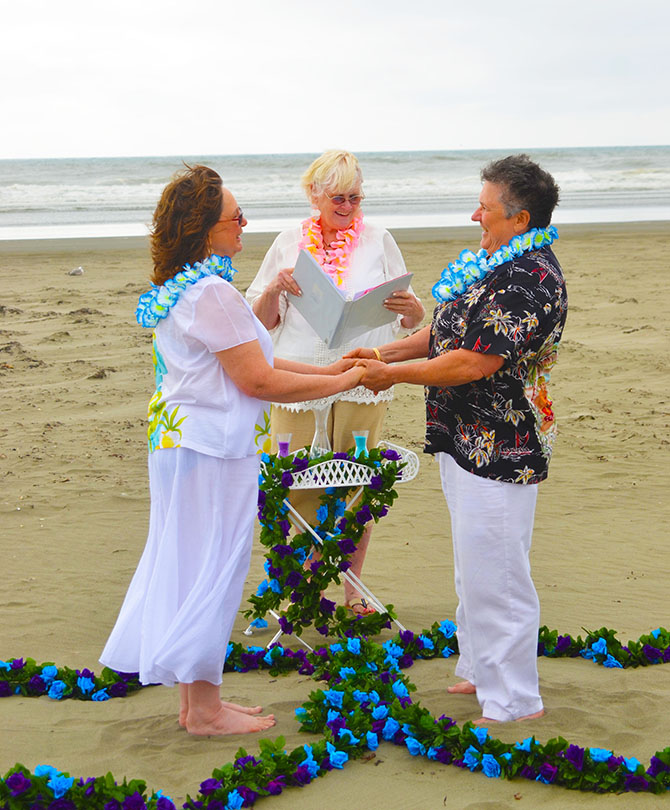 Weddings By The Sea - Officiant performing beachside Lesbian wedding ceremony