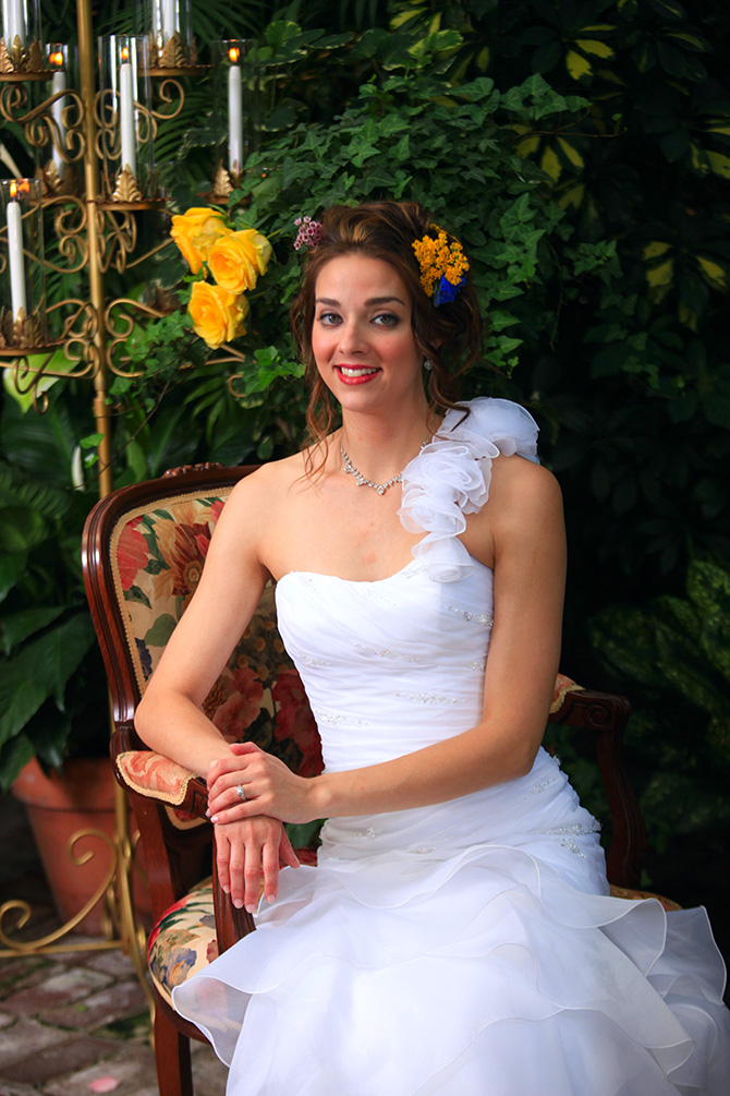 Memories Are Forever -  Closeup shot of bride, candleabra and lush green foliage
