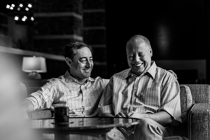 The R2 Studio Phoenix, Arizona grooms sitting smiling black and white