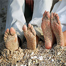 Trinity Hawaiian Weddings - Couple's feet in the sand